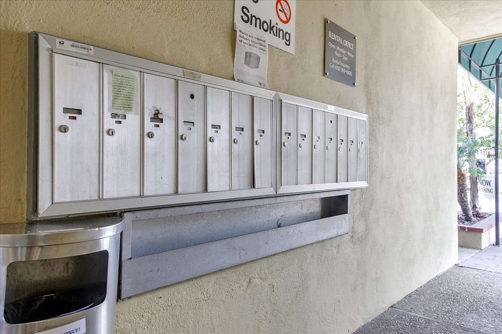 a row of white mail boxes on the side of a building