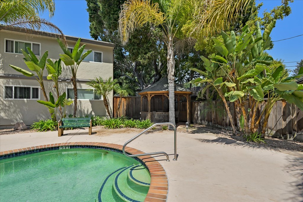 a backyard with a swimming pool and a house