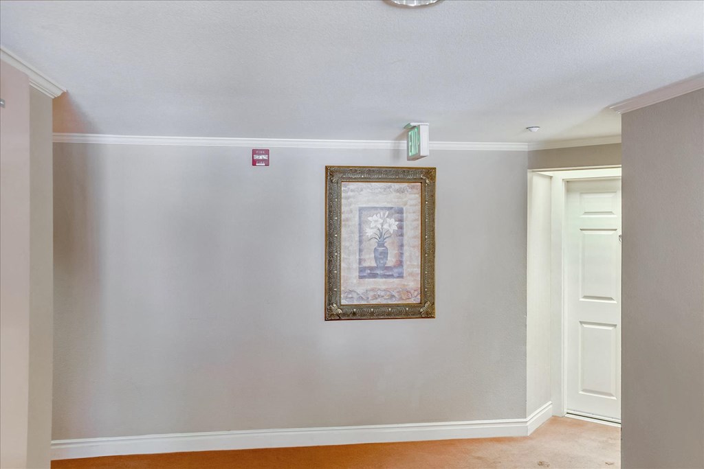 A picture frame with a painting hanging on a wall.