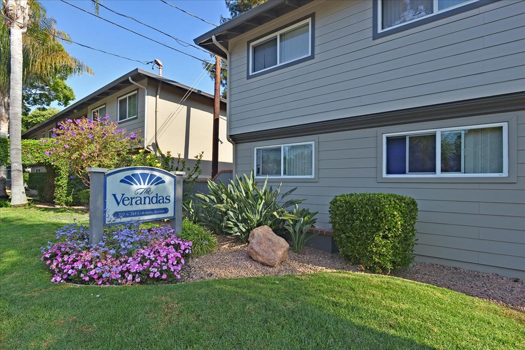 a yard with a sign in front of a house