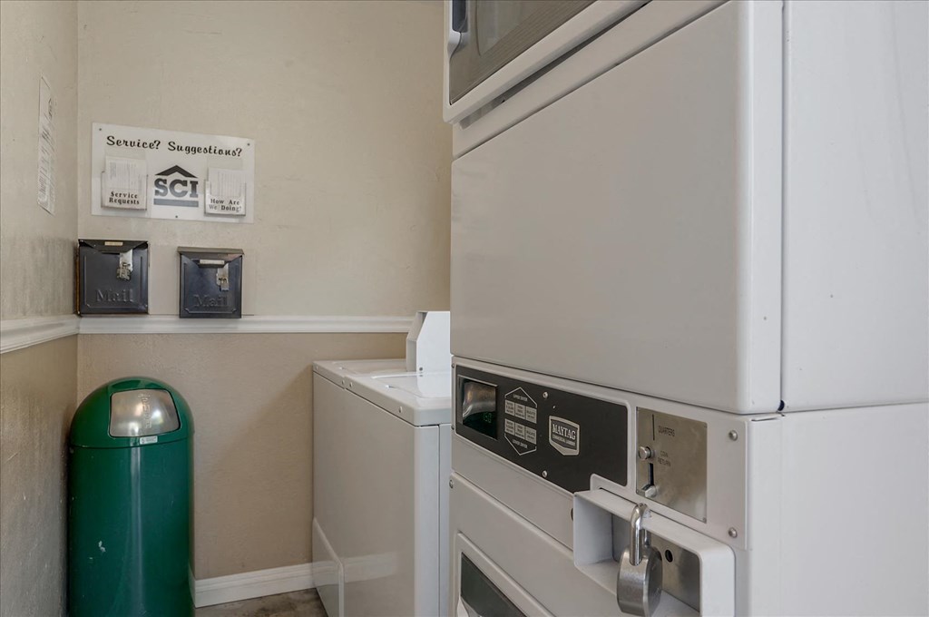 a washer and dryer in a laundry room with a refrigerator