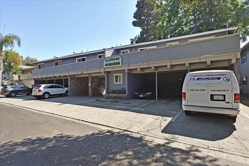 a van parked in front of a building with a parking lot