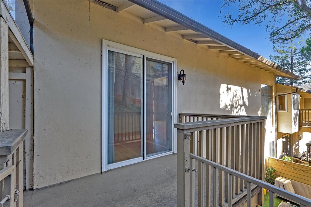 a balcony with a sliding glass door and a deck