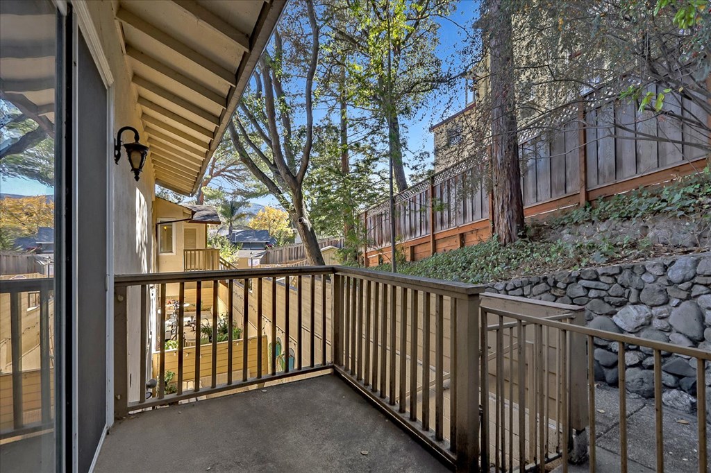 a balcony with a view of a yard and a house