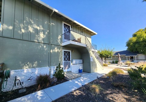A building with a white wall and a blue door.