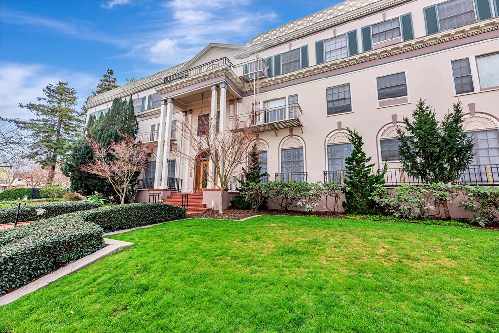 A large, two-story building with a balcony on the second floor.