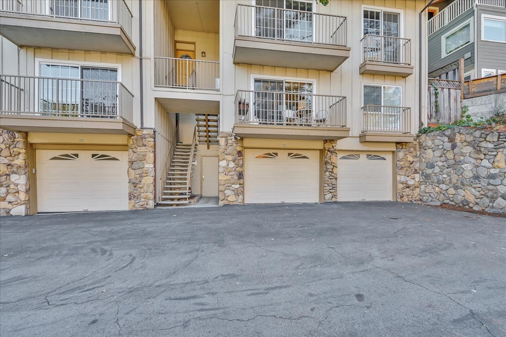 an empty parking lot in front of an apartment building