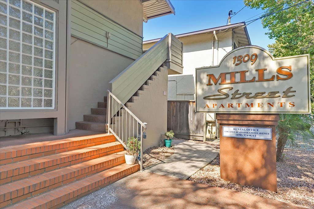 the entrance to a building with a sign for mills street apartments