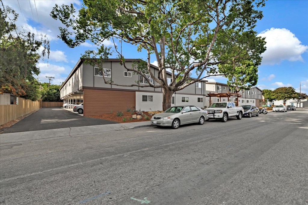 a city street with cars parked in front of buildings
