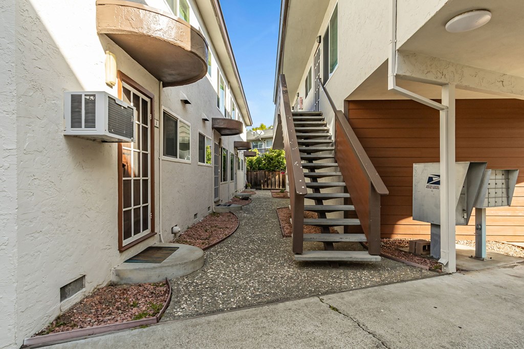 A white building with a mailbox on the right side.