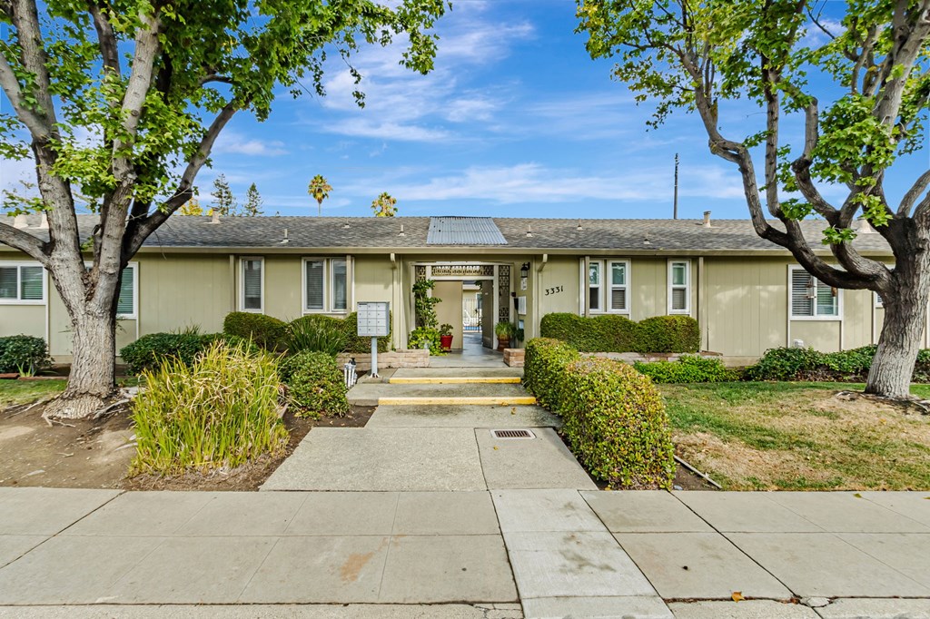 A building with a tree in front of it.