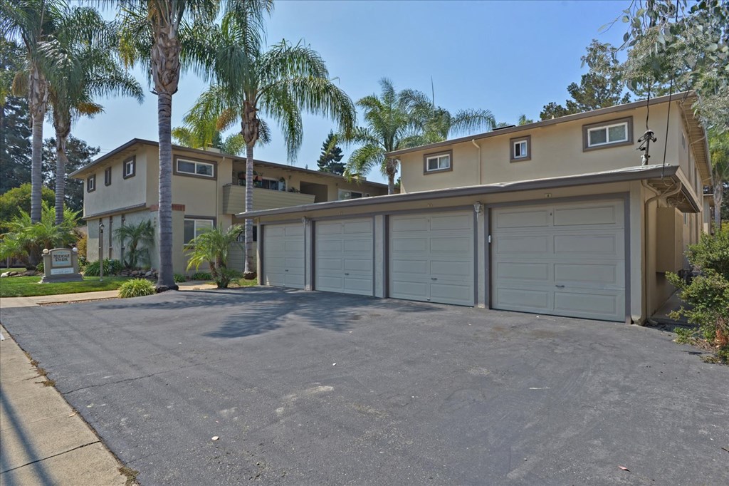 a garage with a row of garage doors in front of a house