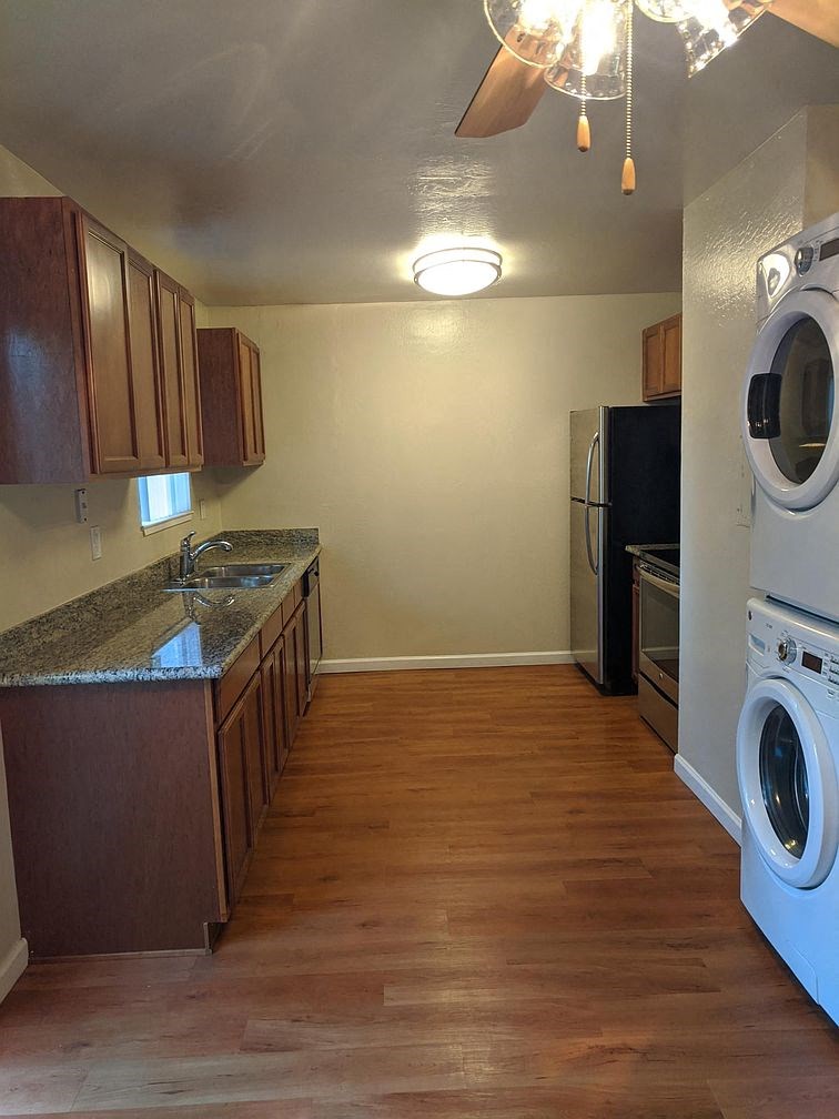 a kitchen with a washing machine and a dryer in it