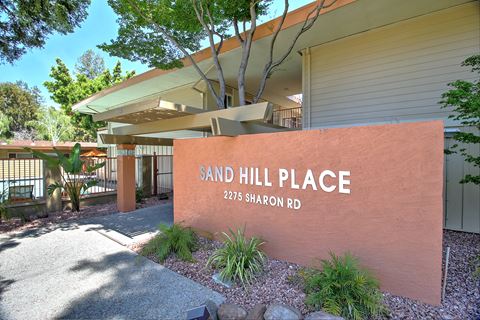 a sand hill place sign in front of a building