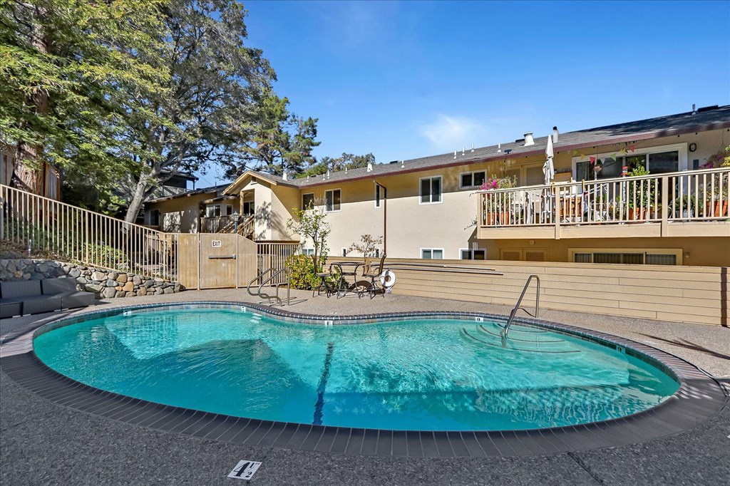 a resort style pool with a building in the background