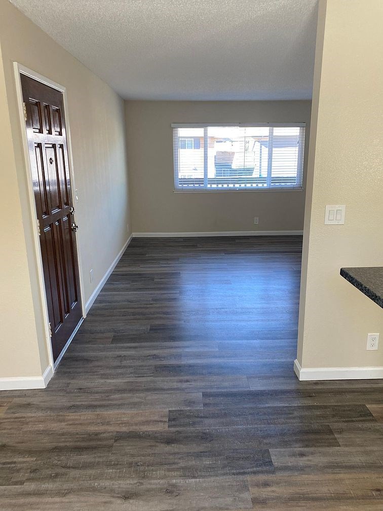 A room with wooden flooring and a window.