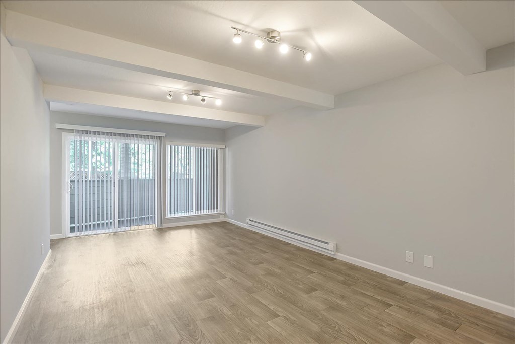 A room with a sliding glass door and a window.