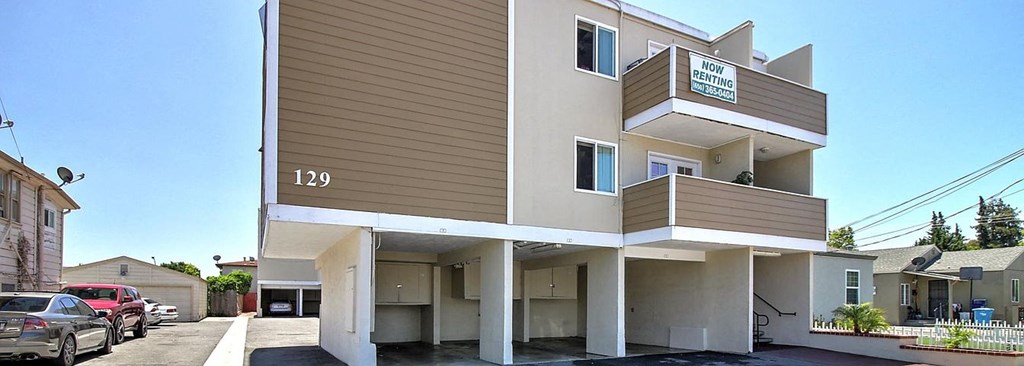 a apartment building with cars parked in front of it