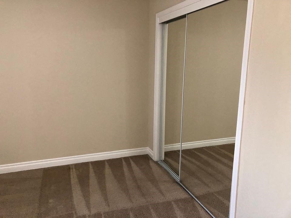 a closet with a pair of mirrored closet doors