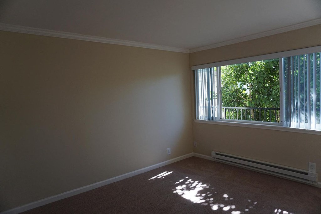 an empty living room with a large window