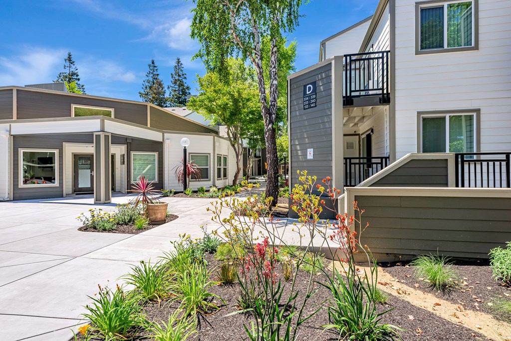 A modern building with a landscaped front yard.