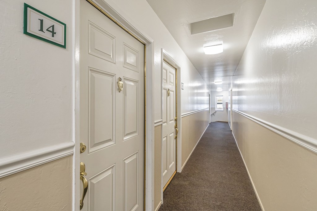 A hallway with a door numbered 14 on the wall.