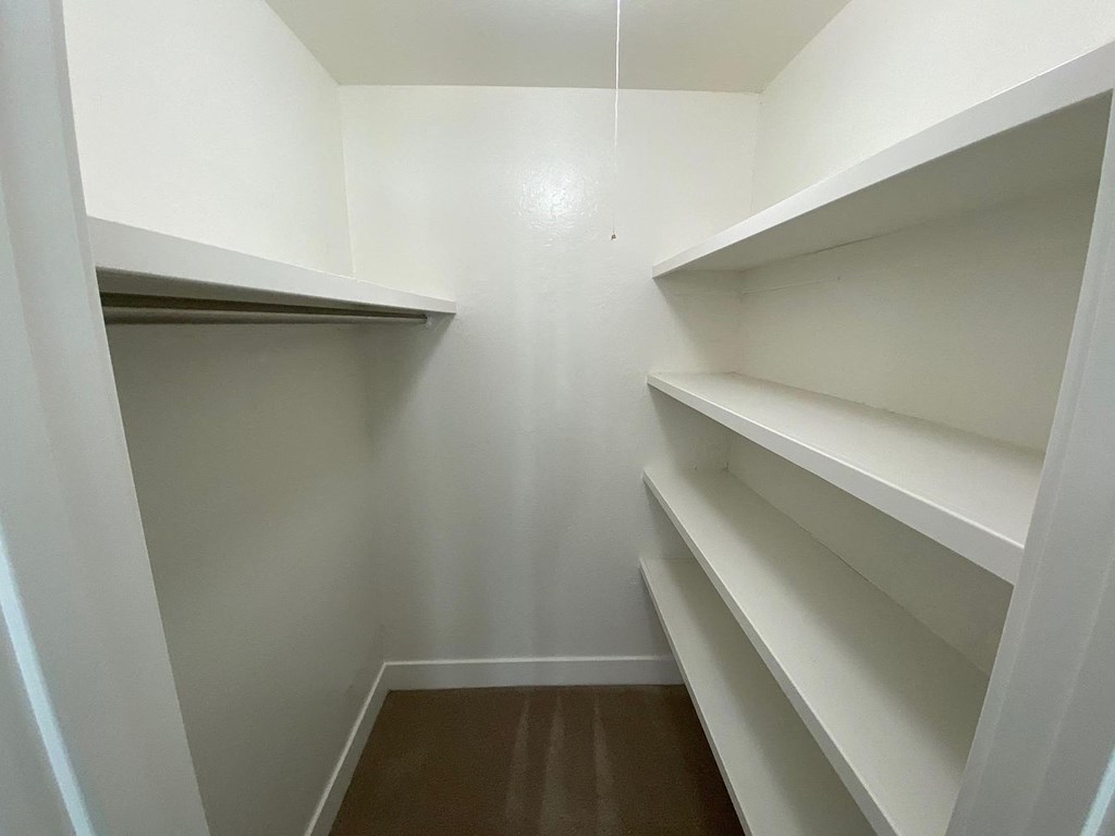Empty white shelves in a room.