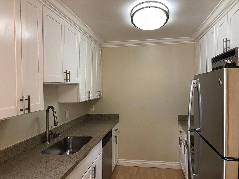 a kitchen with a sink and a refrigerator