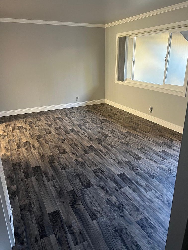 a room with wood flooring in an empty room