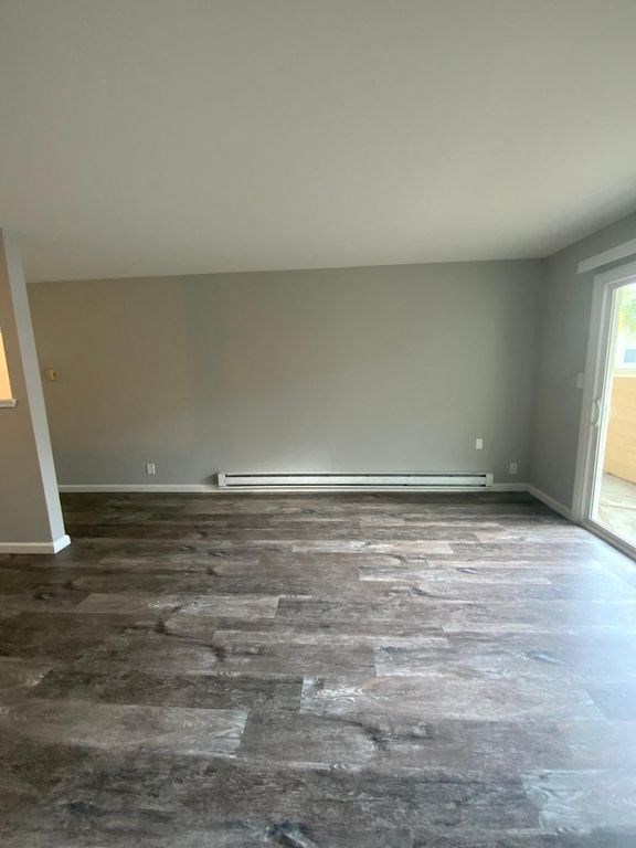 A room with a grey floor and a window.