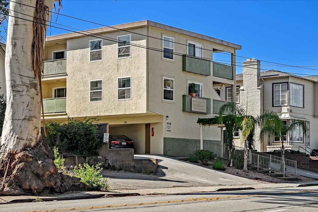 an apartment building with a car parked in front of it