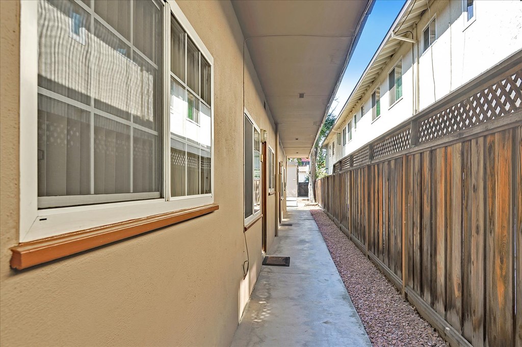 a long corridor with windows on the side of a building