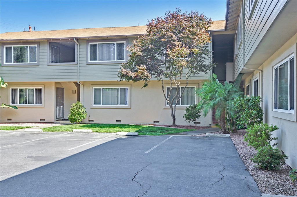 A building with a parking lot in front of it.