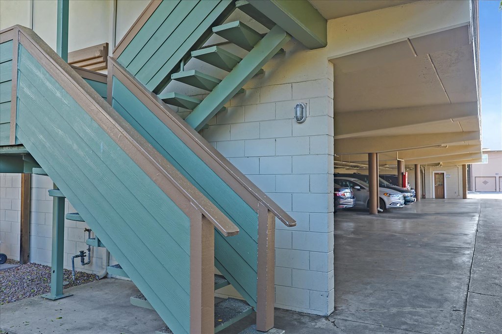 a building with stairs and a parking lot