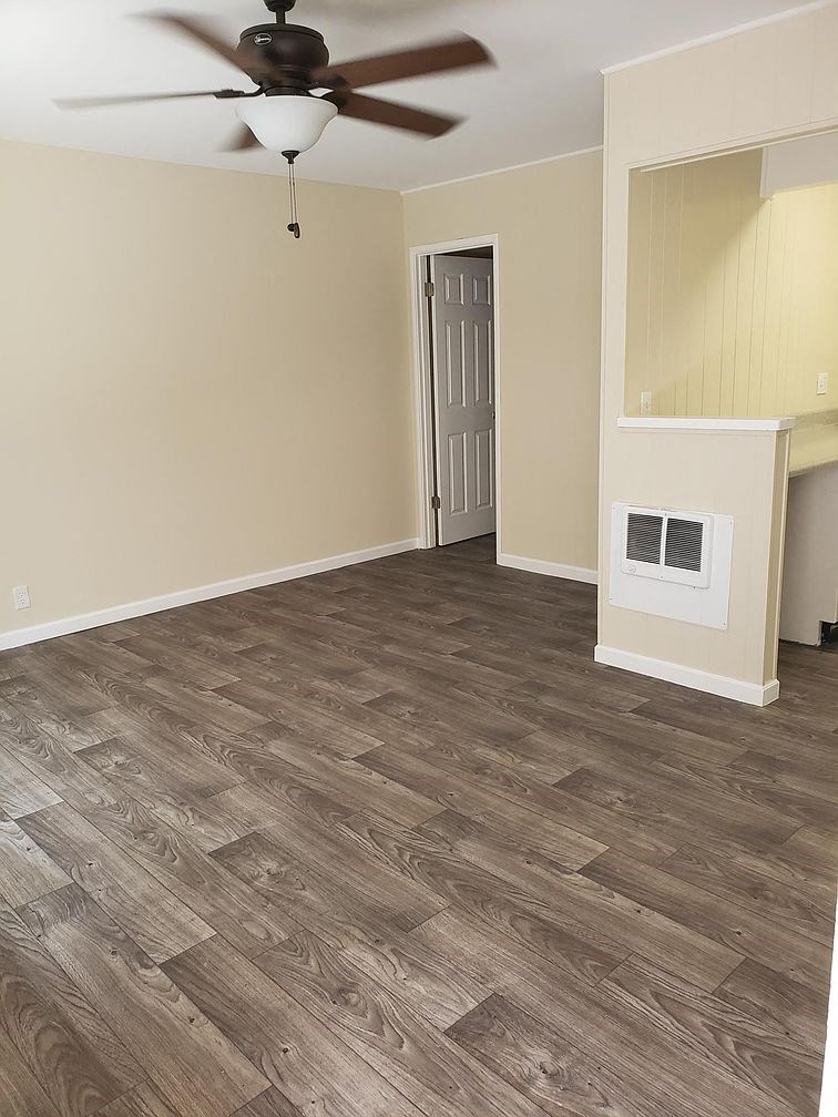A room with a ceiling fan and light fixture.