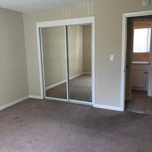 A room with a sliding door and carpeted floor.