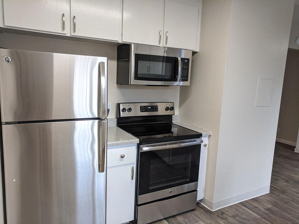 a kitchen with stainless steel appliances and a refrigerator