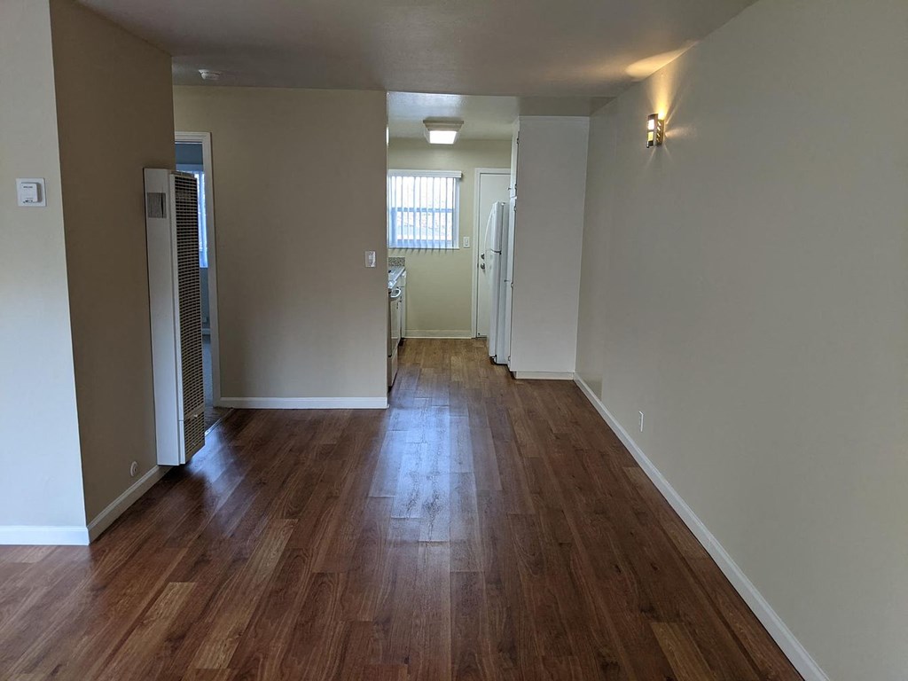 A room with wooden floors and white walls.