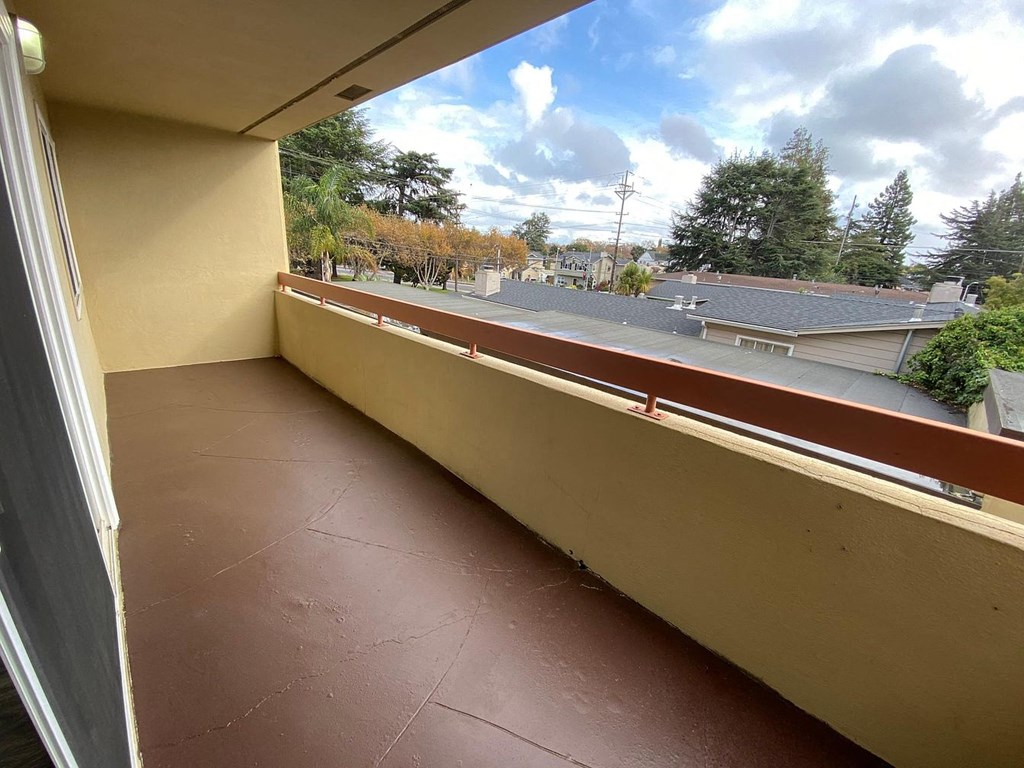 A balcony with a view of a residential area.