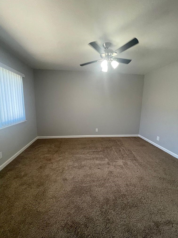 an empty room with a ceiling fan