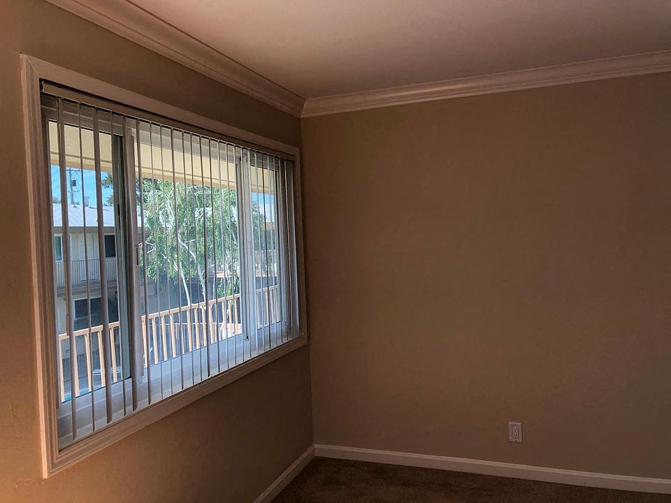 an empty living room with a large window