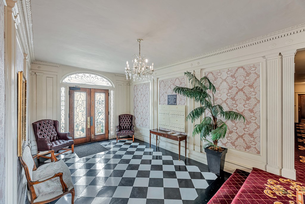 A room with a checkered floor and a chandelier.
