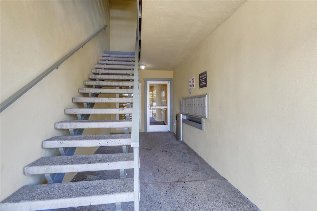 a set of stairs leading up to a hallway with a door