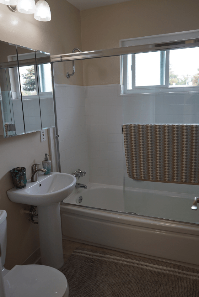 a small bathroom with a sink and a bath tub