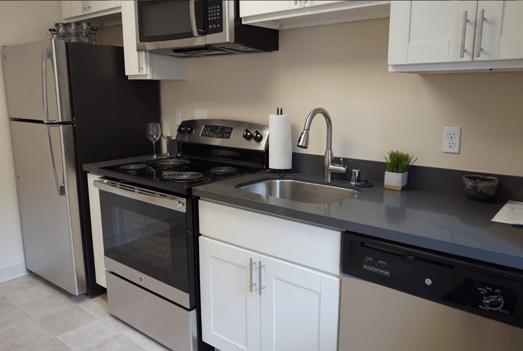 a kitchen with a sink and a stove and a refrigerator