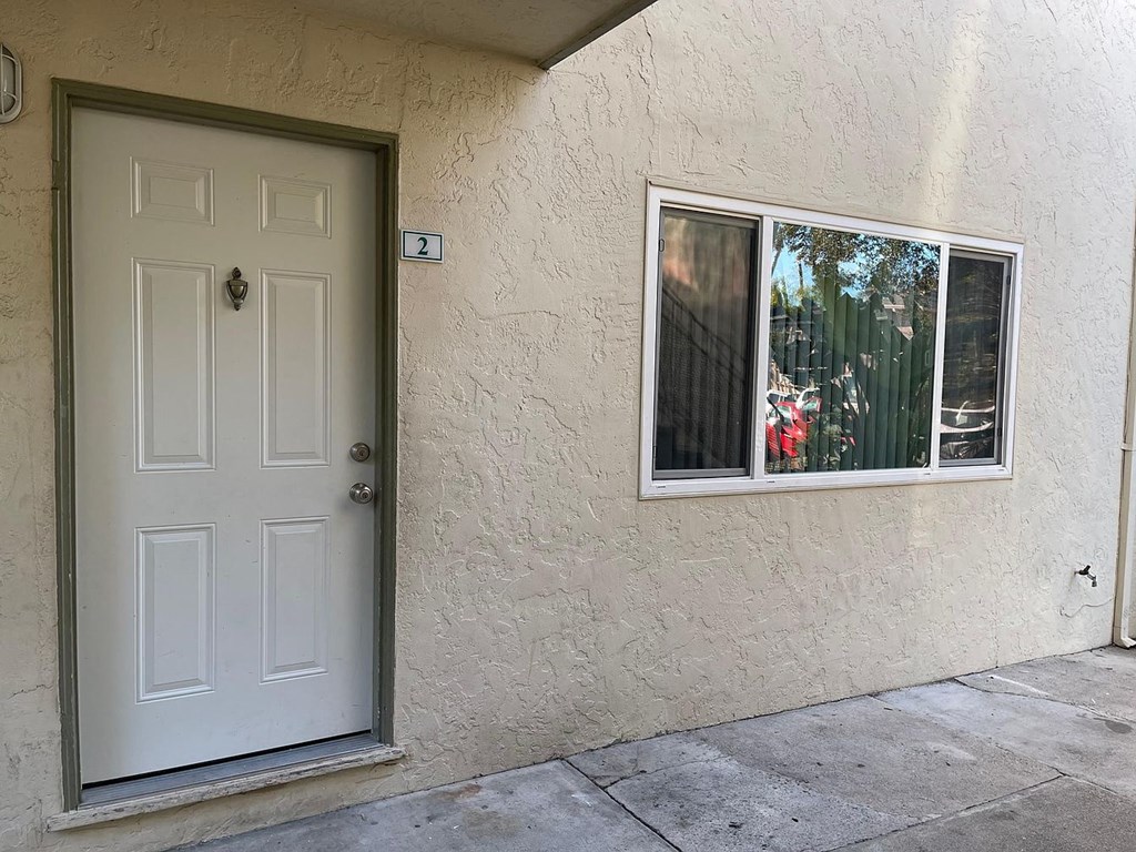A white door with a number 2 on the wall above it.