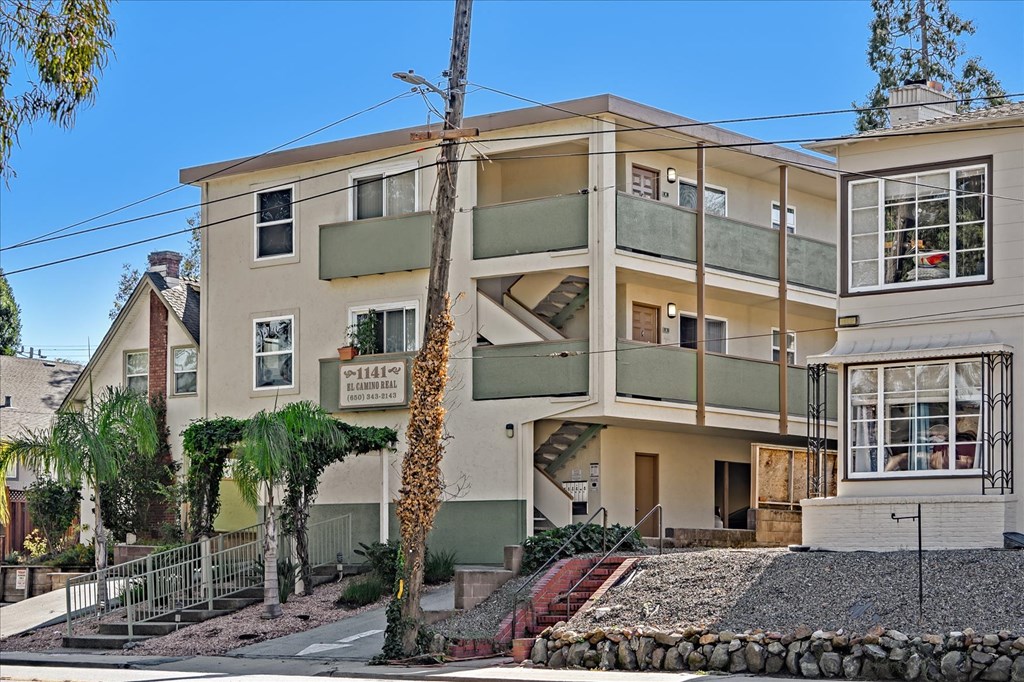 an apartment building with a staircase in front of it