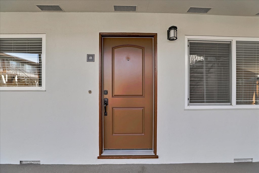 the front door of a house with a brown door