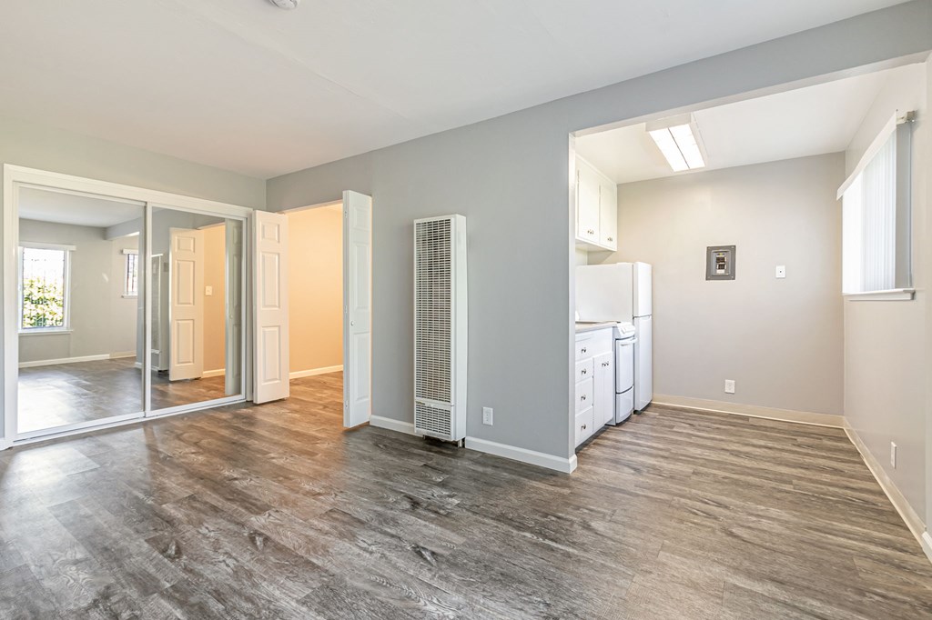 A spacious kitchen with a refrigerator, cabinets, and a countertop.