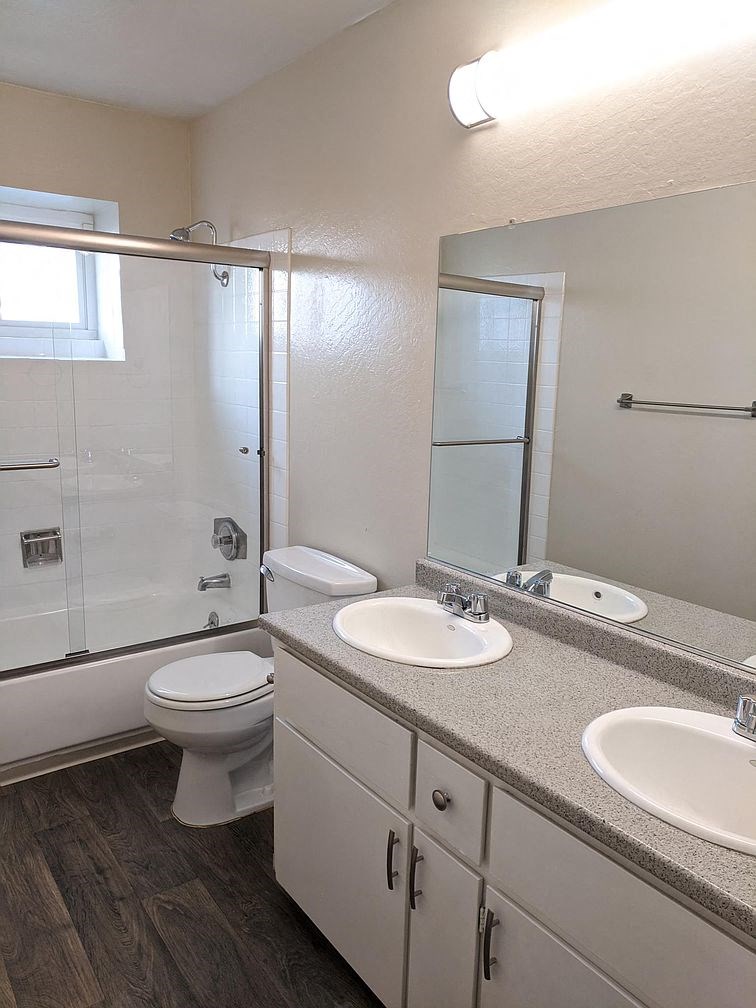 a bathroom with a toilet sink and a shower